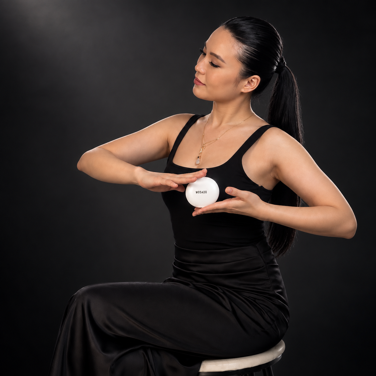 WOSADO cinematic campaign portrait holding the white WOSADO case